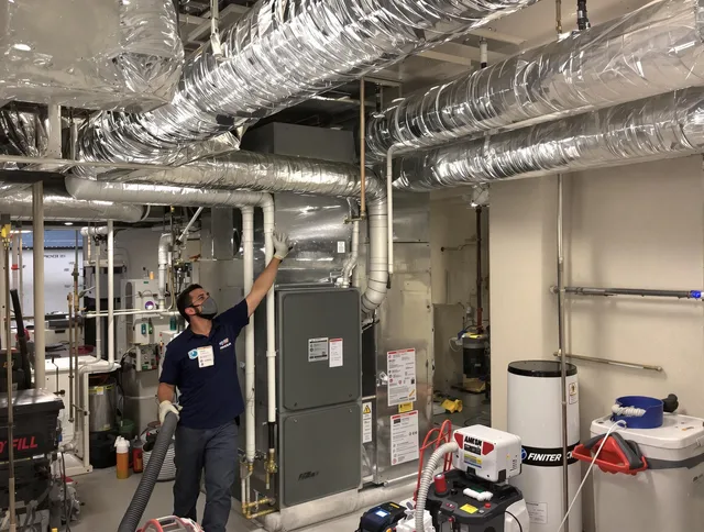 Norton Air Duct Cleaning specialist performing thorough furnace duct cleaning in a Norton residence