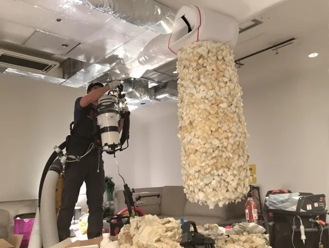 Norton Air Duct Cleaning technician performing precision vacuum insulation removal in a residential property in Norton
