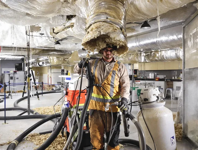 Professional vacuum insulation removal by Norton Air Duct Cleaning expert in Norton